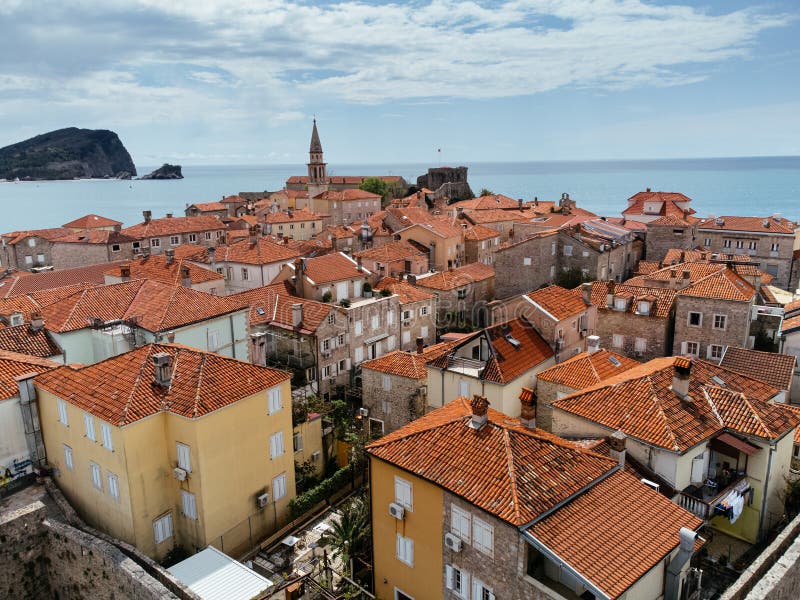 Aerial view of the Old Budva town, port, beach, and mountains. royalty free stock images