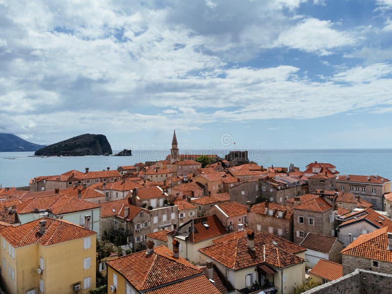 Aerial view of the Old Budva town, port, beach, and mountains. stock photos