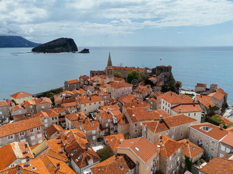 Aerial view of the Old Budva town, port, beach, and mountains. stock photos