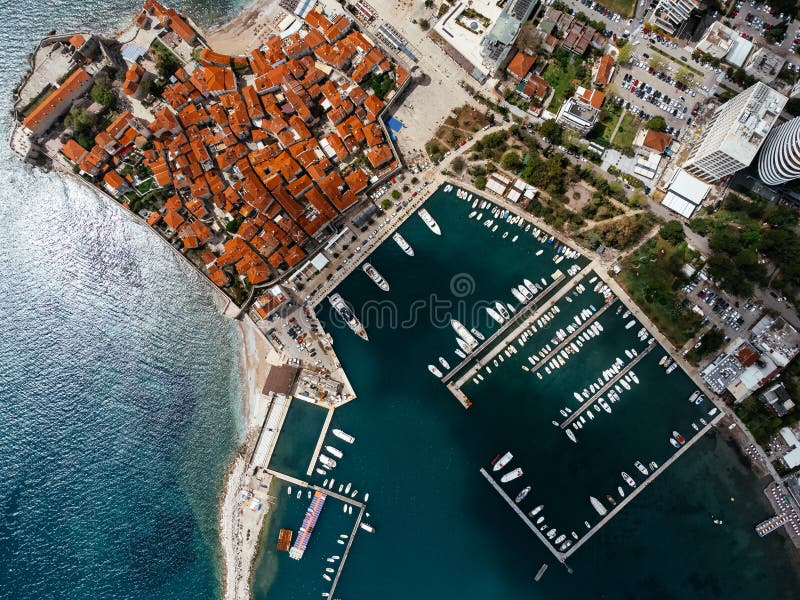 Aerial view of the Old Budva town, port, beach, and mountains. royalty free stock photos