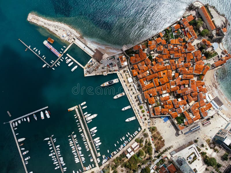 Aerial view of the Old Budva town, port, beach, and mountains. stock images