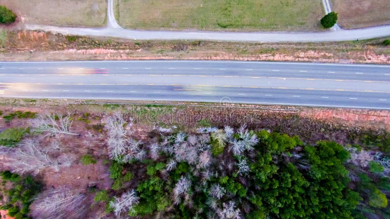 Aerial view over country road forest and fields royalty free stock photography