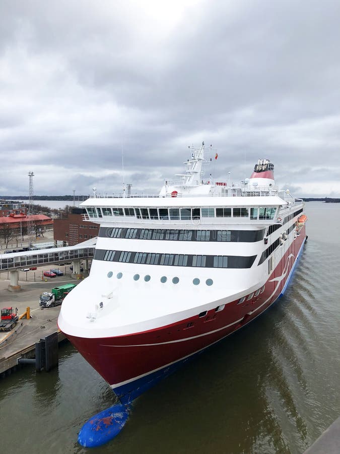 Aerial view of a passenger ship in alongside the terminal of port. Nose of the cruise ship near the pier. Aerial photography stock photo Aerial view of a passenger ship in alongside the terminal of port. Nose of the cruise ship near the pier. Aerial photography stock photo