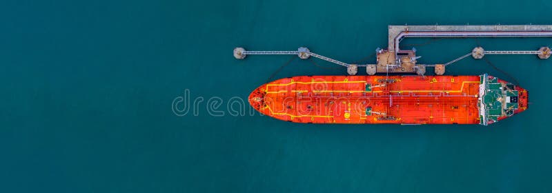 Aerial view red cargo tanker ship vessel at port with marine loading arms, Global business oversea commercial trade logistic