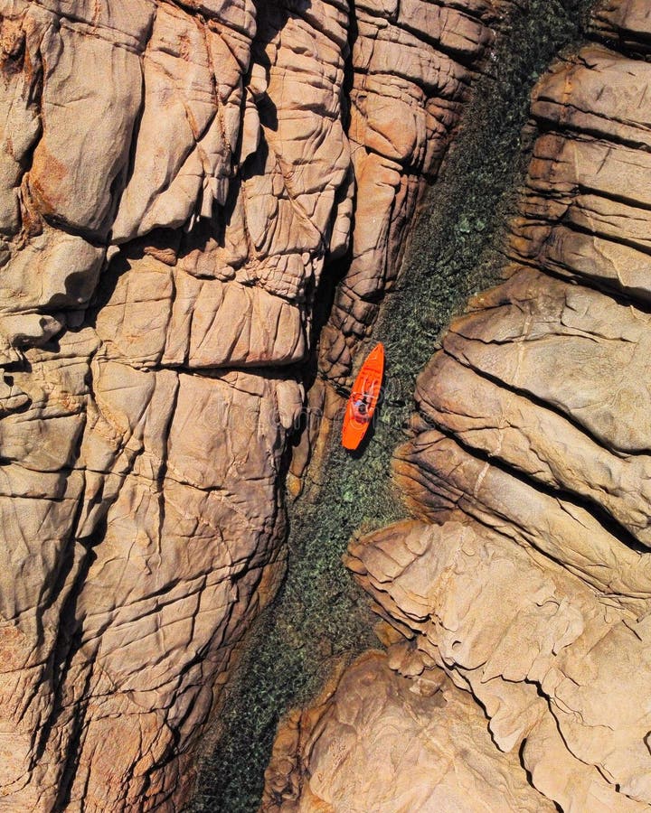 Aerial View of Red Kayak in the Canyon Surrounded by Steep Rocks Stock
