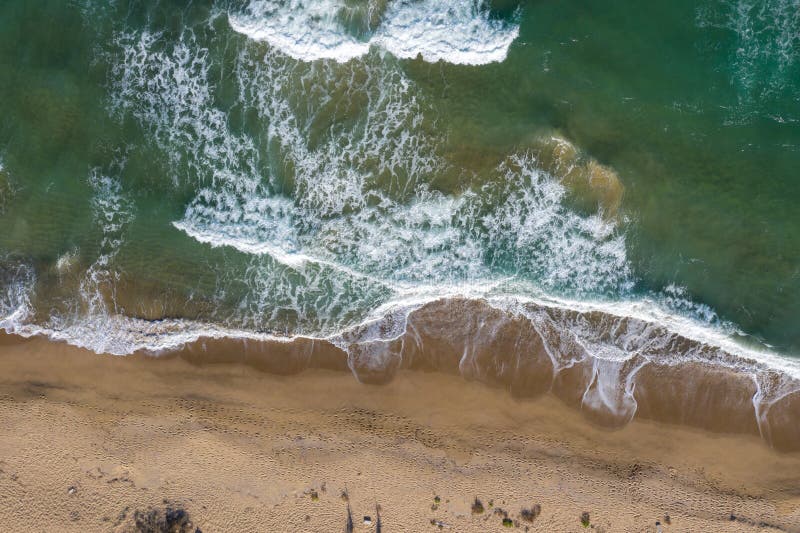 Aerial view of a remote sandy beach and sea waves stock photo