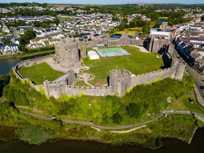 Aerial view of the ruins of a large, ancient castle in Wales Pembroke Castle