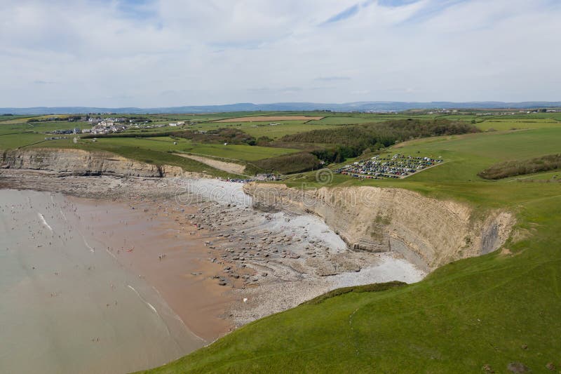 Aerial view of sea cliffs, rock formations and a sandy beach Southerndown, Wales, UK