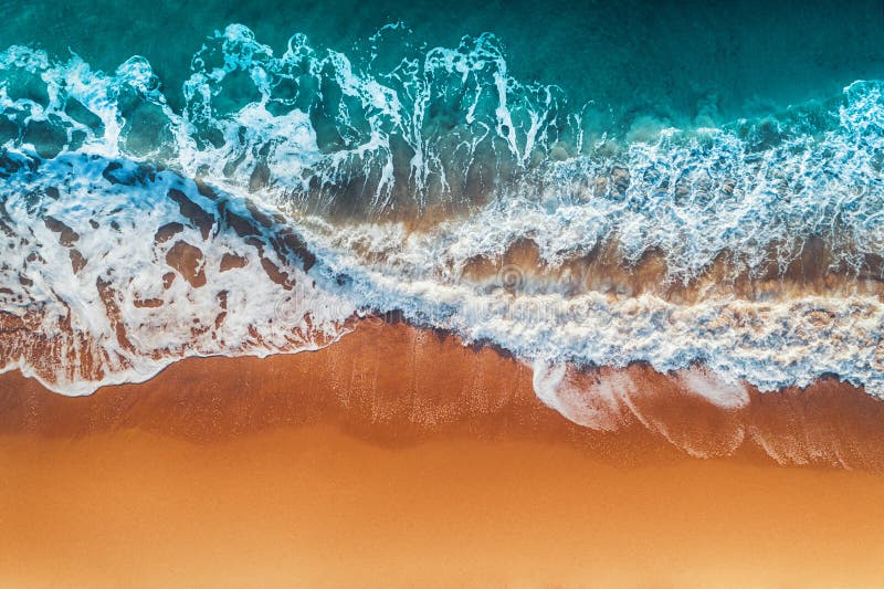 Aerial view of sea waves and sandy beach.  stock images