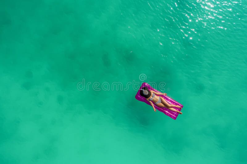 Aerial View of Slim Woman Swimming on the Swim Mattress in t