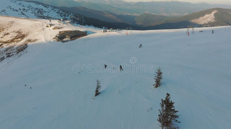 Aerial view snowboard snowy mountain winter forest with chair lift ski resort stock video