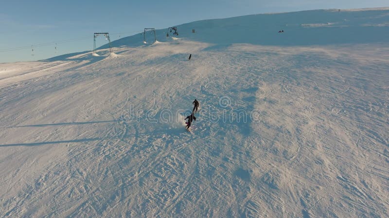 Aerial view snowboard snowy mountain winter forest with chair lift ski resort stock video footage