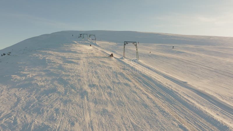 Aerial view snowboard snowy mountain winter forest with chair lift ski resort stock video
