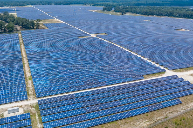 Massive solar panel farm from an aerial view in Northern Florida covering many acres of land. Solution for clean energy. Massive solar panel farm from an aerial view in Northern Florida covering many acres of land. Solution for clean energy.