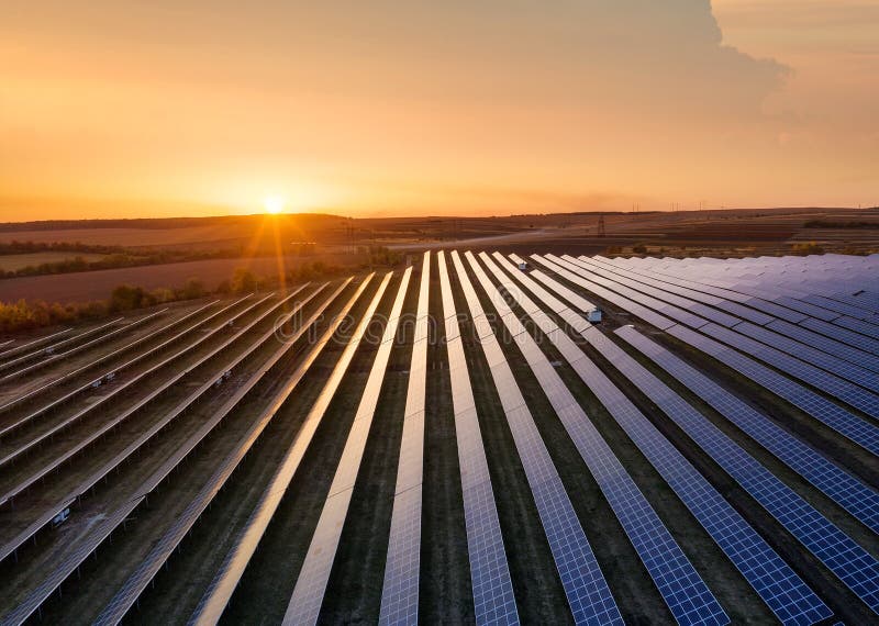 Aerial view on the solar panel. Technologies of renewable energy sources. View from air. Industrial landscape during sunset.