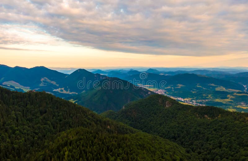 Aerial view to Mala Fatra mountains in Slovakia. Sunrise above mountain peaks and hills in far. Beautiful nature, vibrant colors.