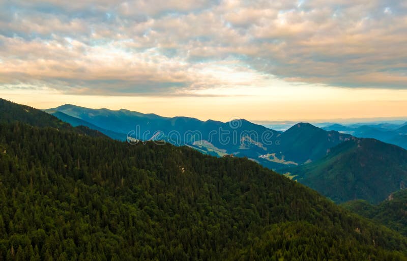 Aerial view to Mala Fatra mountains in Slovakia. Sunrise above mountain peaks and hills in far. Beautiful nature, vibrant colors.