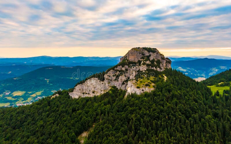 Aerial view to Mala Fatra mountains in Slovakia. Sunrise above mountain peaks and hills in far. Beautiful nature, vibrant colors.