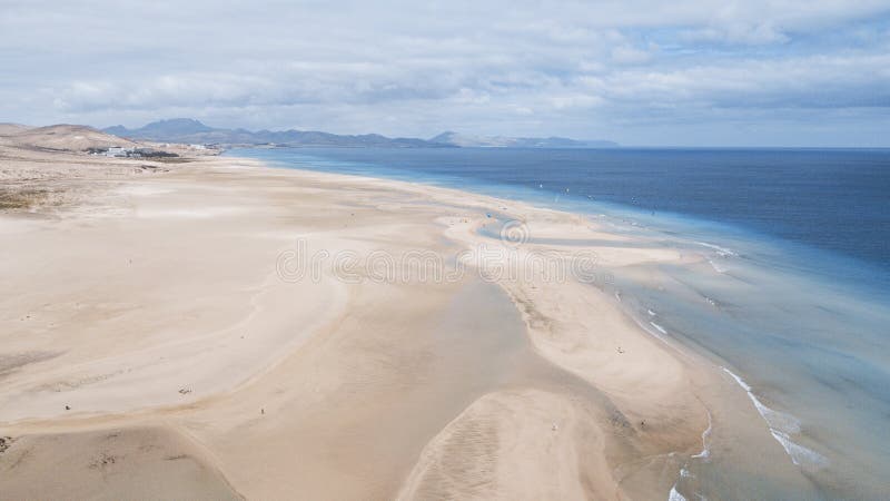 Aerial view of tropical caribbean white sand beach and transparent clean water with blue ocean and sky in background. Concept of