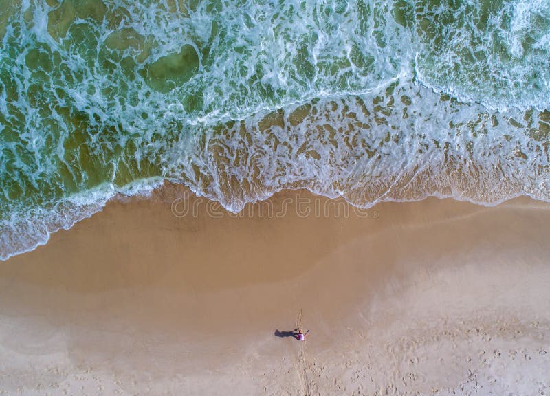 Aerial view of the waves crashing on the beach at Perdido Key beach in Pensacola Florida