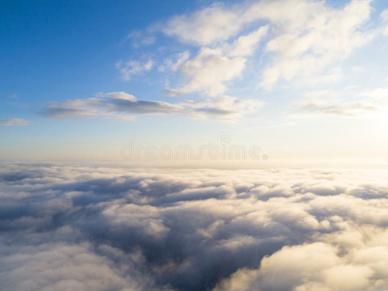 Aerial view White clouds in blue sky. Top view. View from drone. Aerial bird`s eye view. Aerial top view cloudscape. Texture of c