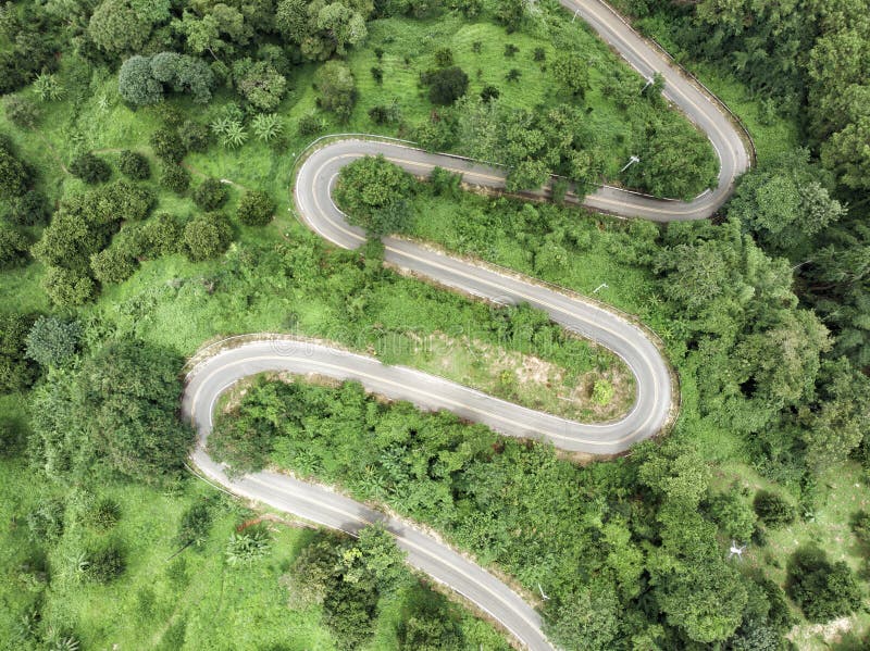 Aerial view of winding asphalt road for background.Scenic view of Sharp curve road on the mountain by drone safty drive and travel