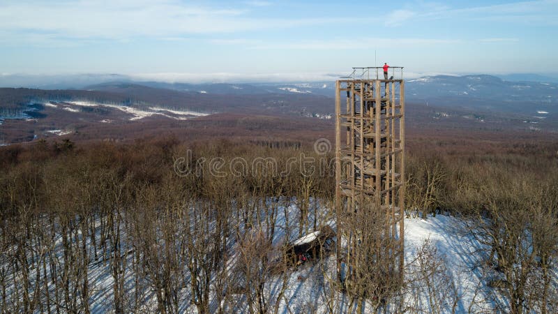 Aerial view of wooden lookout tower on the top of Velka Homola in winter