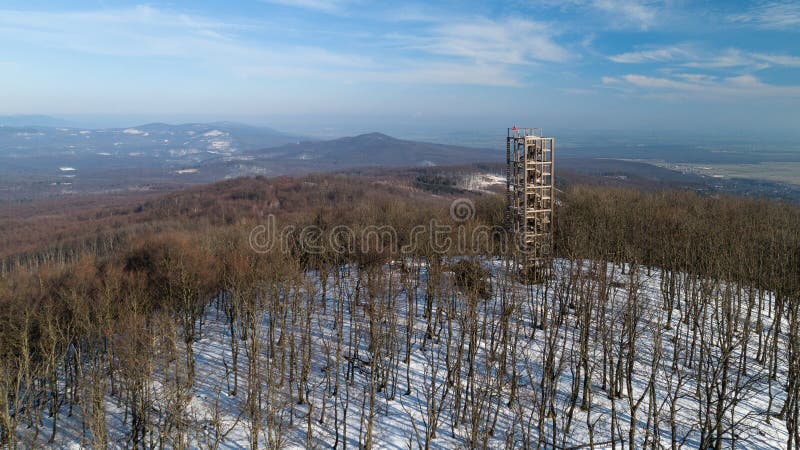 Aerial view of wooden lookout tower on the top of Velka Homola in winter