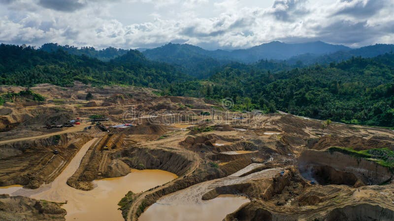 Aerial view of Work of trucks and the excavator in an open pit on gold mining. Central Sulawesi, Indonesia, March 3, 2022
