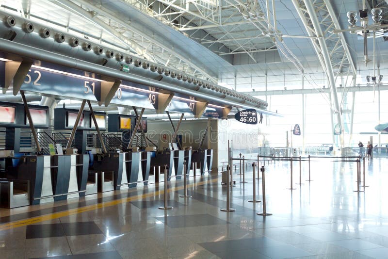 Modern airport architecture with empty counters and  check-in information signage under natural light. Modern airport architecture with empty counters and  check-in information signage under natural light