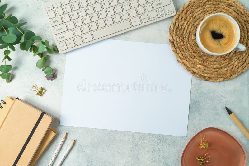 Aesthetic home office desk with eco friendly stationary, paper note and eucalyptus branches. Top view, flat lay