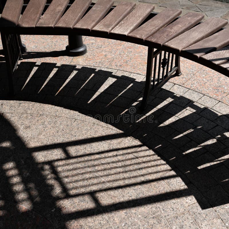 Aesthetic modern garden house, courtyard, gazebo furniture, street architecture. Brown wooden bench and stone sidewalk