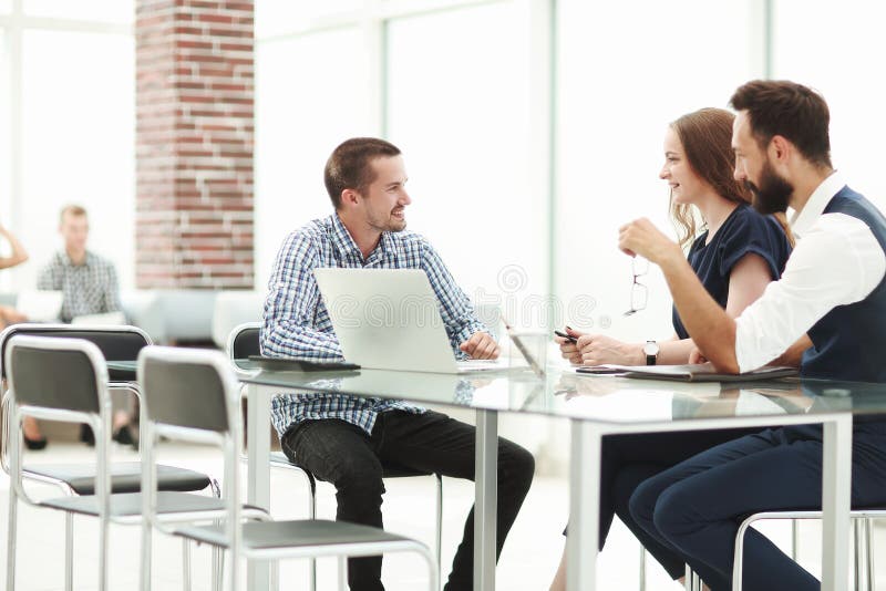 Business team discussing something sitting at the office table. the concept of a startup