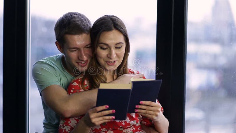 Affectionate couple spending time together reading