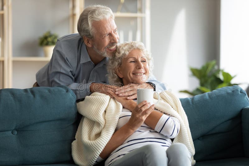 Affectionate senior married couple enjoying sweet tender cozy moment. stock images