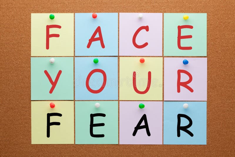 Face your fear text on notes pinned on cork board. Healthy concept. Face your fear text on notes pinned on cork board. Healthy concept