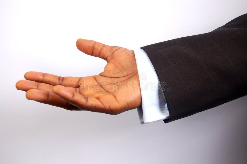 This is an image of a black businessman offering his hand. This is a metaphor for business assurance, business trust etc. (Please let me know where the image will be used by leaving a message in the Comments Section). This is an image of a black businessman offering his hand. This is a metaphor for business assurance, business trust etc. (Please let me know where the image will be used by leaving a message in the Comments Section)