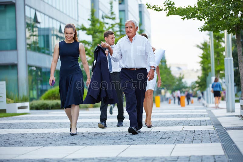 Business team walking together on a way in summer. Business team walking together on a way in summer