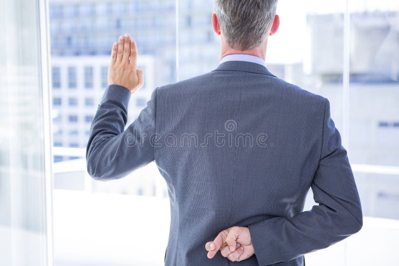 Businessman making a oath while crossing fingers behind his back. Businessman making a oath while crossing fingers behind his back