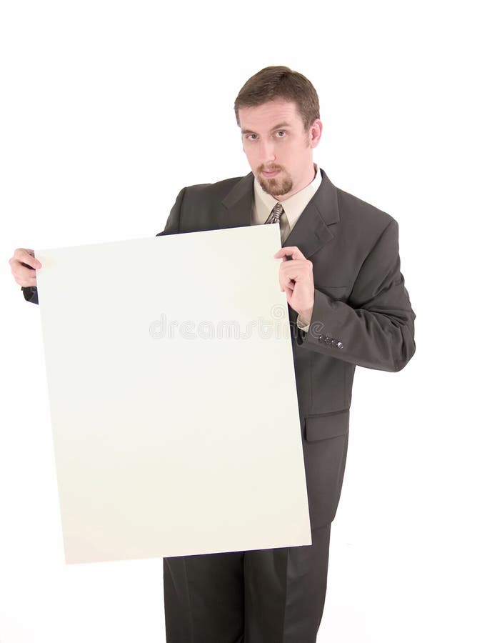 A businessman with arched eyebrow holding a large blank sign, ready for your copy. A businessman with arched eyebrow holding a large blank sign, ready for your copy.