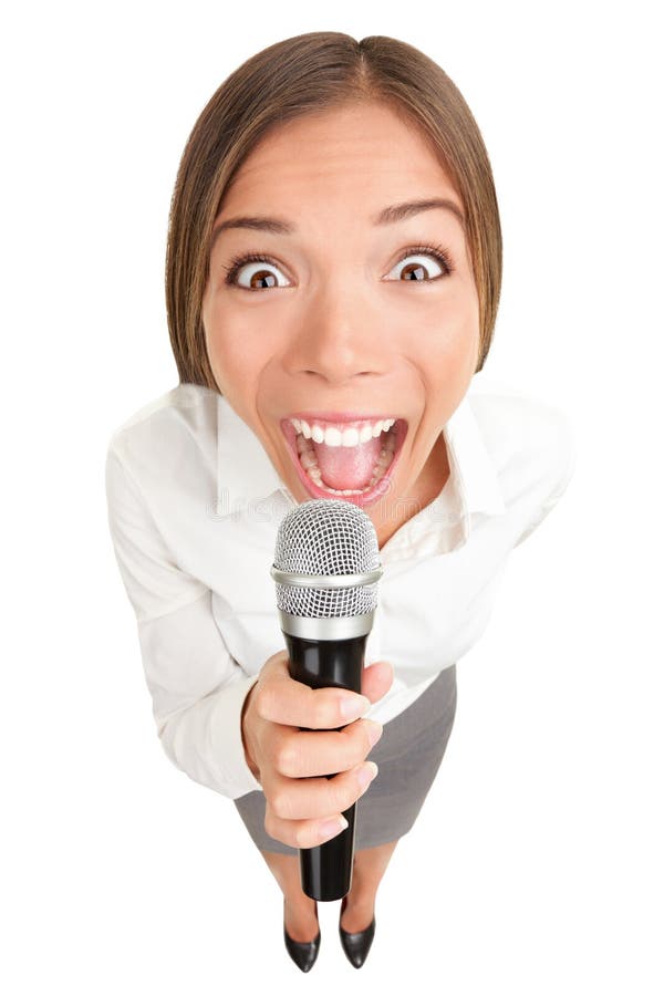 Businesswoman screaming / talking in microphone. Funny photo of young casual business woman holding microphone. Asian Caucasian female model isolated on white background. Businesswoman screaming / talking in microphone. Funny photo of young casual business woman holding microphone. Asian Caucasian female model isolated on white background.