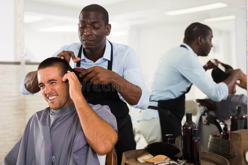 A Barber is Going through the Electric Cutting and Shaving Machine for the  Beard of an African-American Brazilian Boy Stock Image - Image of beauty,  business: 214303807