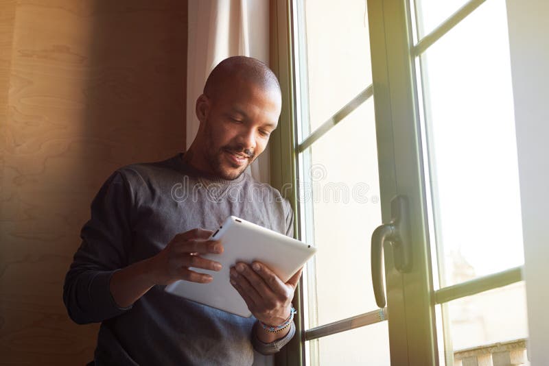 African american black man using electronic tablet at home royalty free stock photography