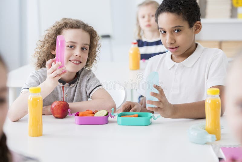 African-american boy and his friend eating fruits