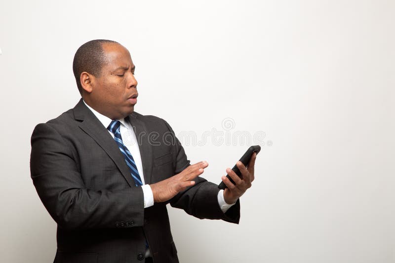 African American Business Man Uses Smart phone on Light Gray Background