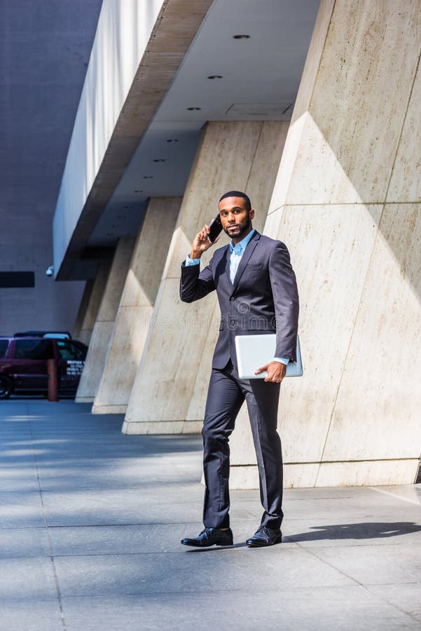 African American businessman with beard talking on cell phone, traveling, working in New York stock image African American businessman with beard talking on cell phone, traveling, working in New York stock image