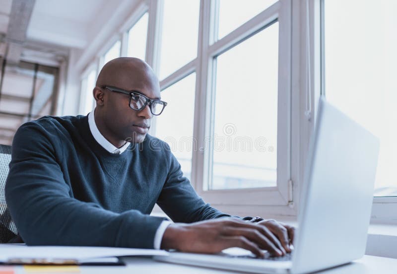 African american businessman working on his laptop stock photography