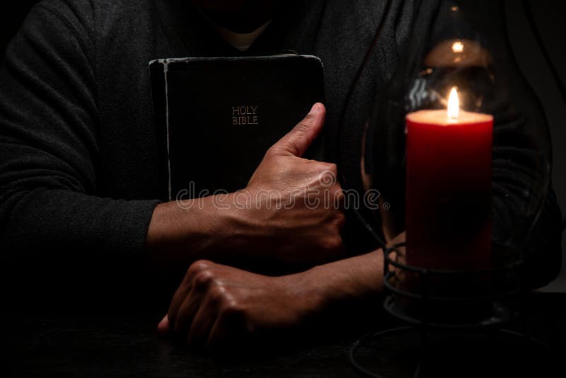 African American Christian Man Embraces the Holy Scriptues, the Bible