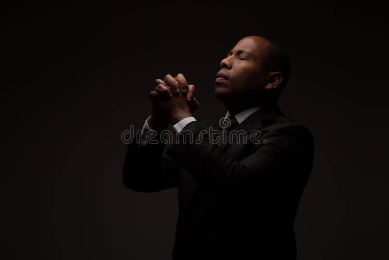 African American Christian Man Praying and Seeking Guidance from God