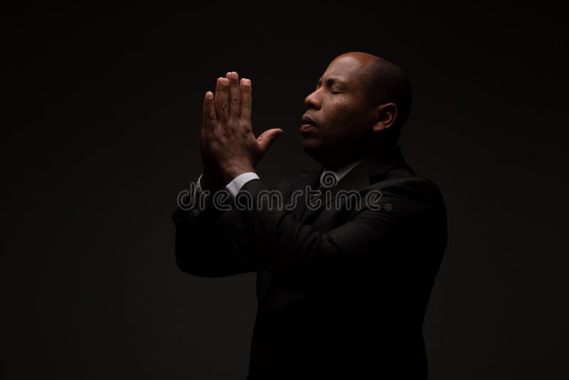 African American Christian Man Praying and Seeking Guidance from God